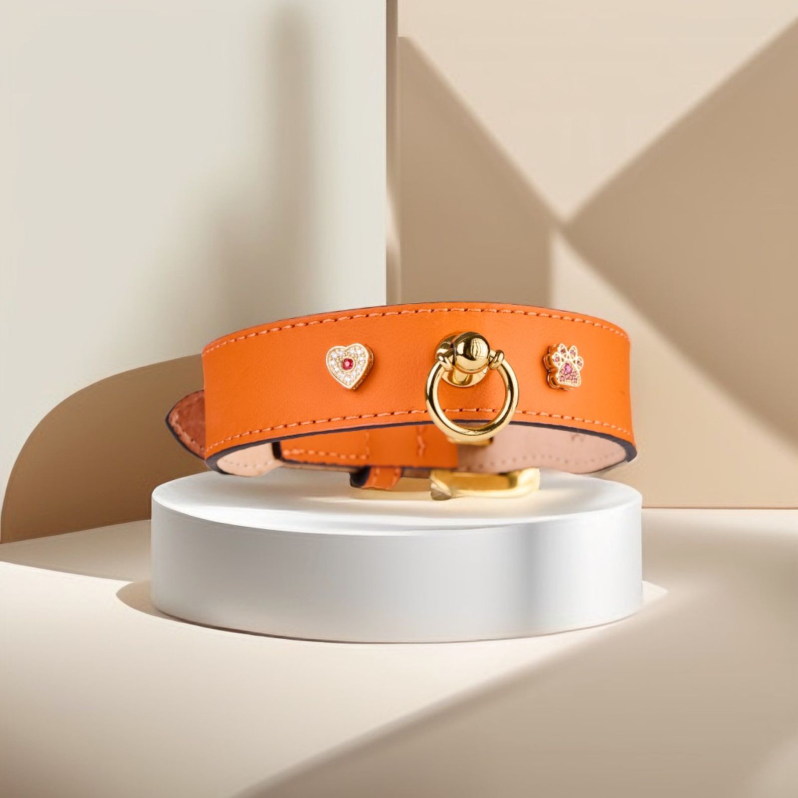 Image of MAYADORO orange dog collar with 14k gold paw and heart charms adorned with diamonds and orange sapphires, crafted with the finest Italian leather, made in Italy.