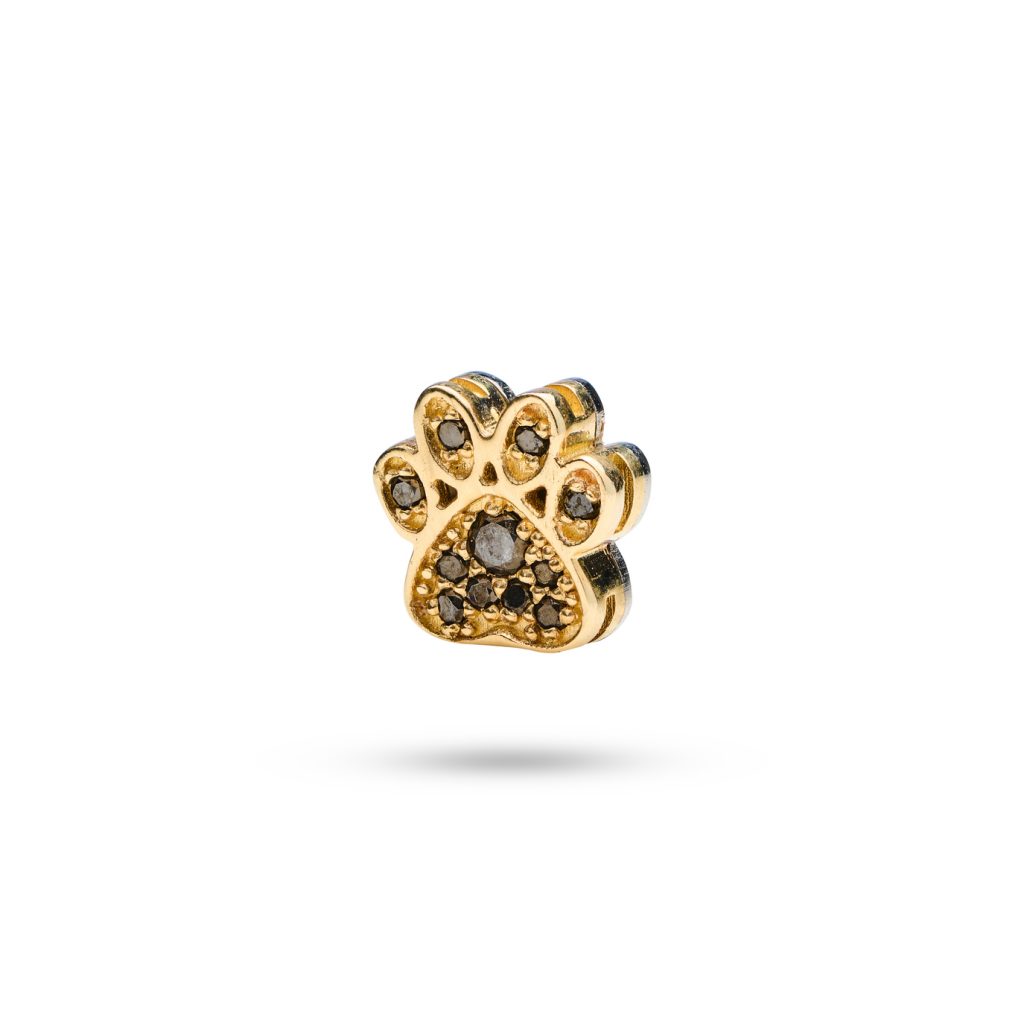 14k gold paw print dog charm adorned with 11 black diamonds, symbolizing cherished moments with your pet.