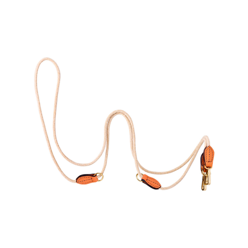 Image of a MAYADORO luxurious lightweight long leash in orange, perfect for very small dogs, crafted with Italian soft calf leather and elegant velvet, adorned with stainless steel metal parts, made in Italy.