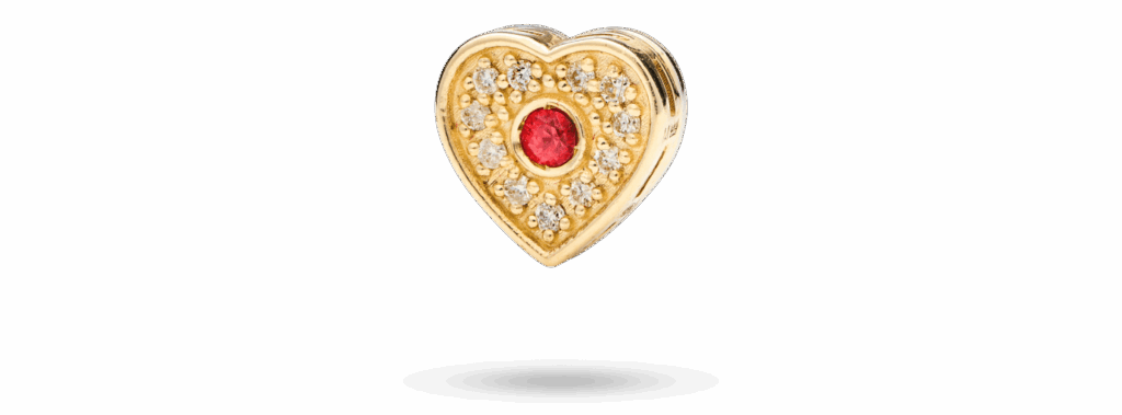 Heart motif in 14k gold with pavé-set diamonds and sapphire detail